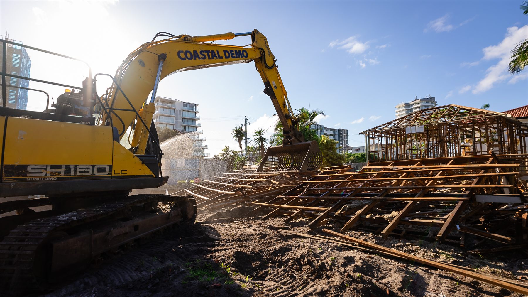 Excavator pushing over house frame during Palm Beach demolition &mdash; Coastal Demolitions